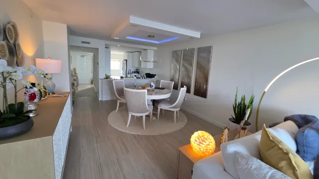 a view of a dining room with furniture and a potted plant