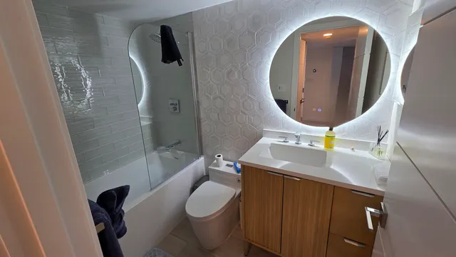 a bathroom with a sink a toilet and shower
