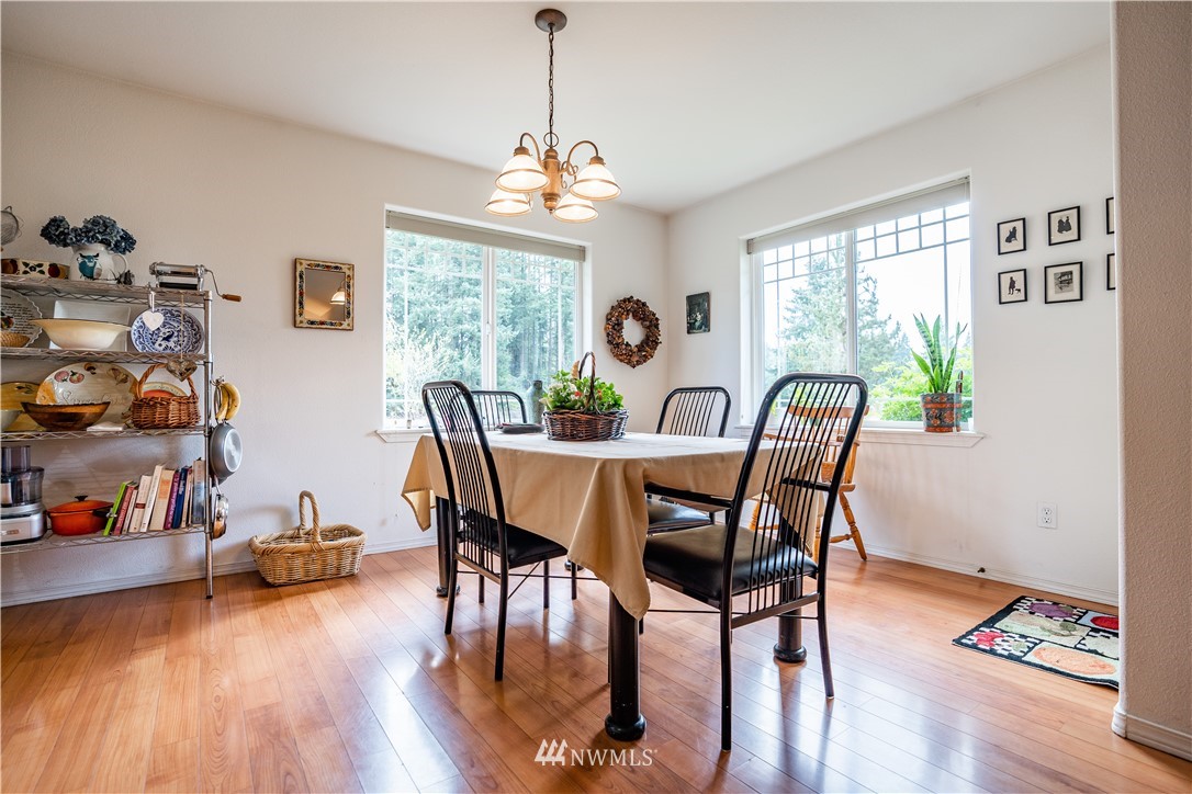 18806 Sams Place Southwest Rochester, WA 98579 - Photo 14 of 40 a view of a dining room with furniture window and wooden floor