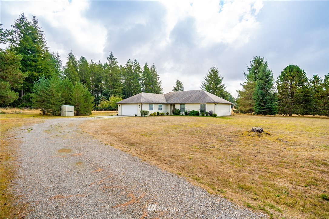 18806 Sams Place Southwest Rochester, WA 98579 - Photo 2 of 40 a yellow house with trees in front of it