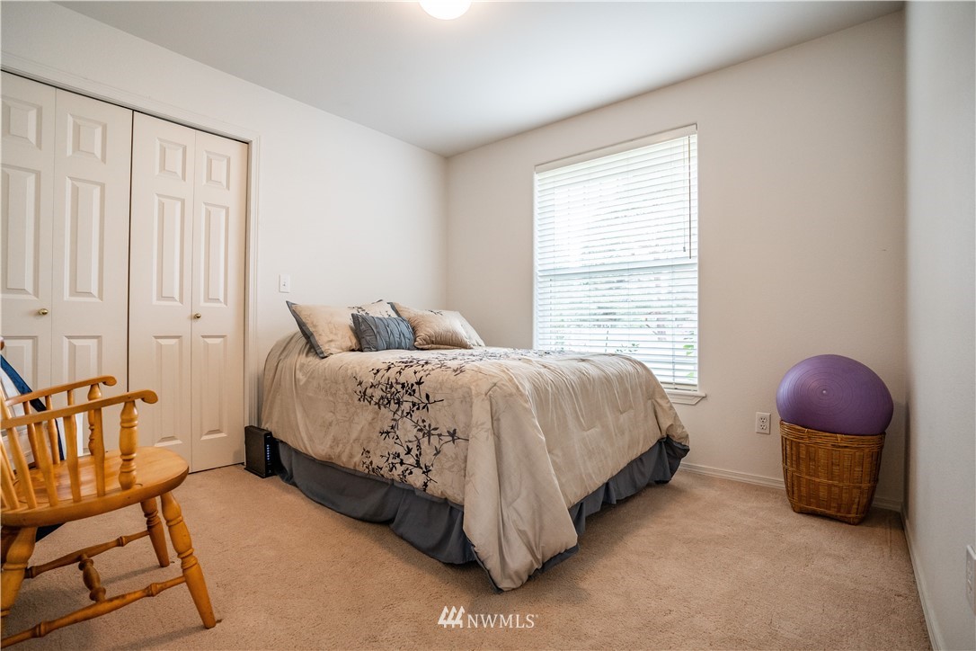 18806 Sams Place Southwest Rochester, WA 98579 - Photo 27 of 40 a spacious bedroom with a bed a couch and dresser