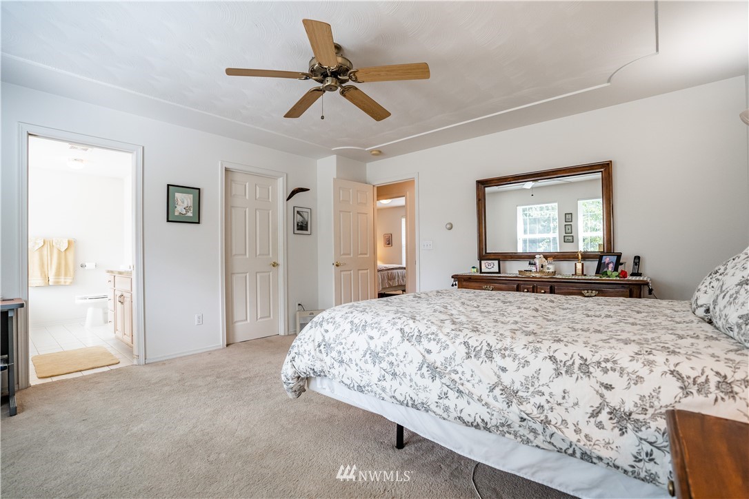 18806 Sams Place Southwest Rochester, WA 98579 - Photo 29 of 40 a bedroom with a bed and a chandelier