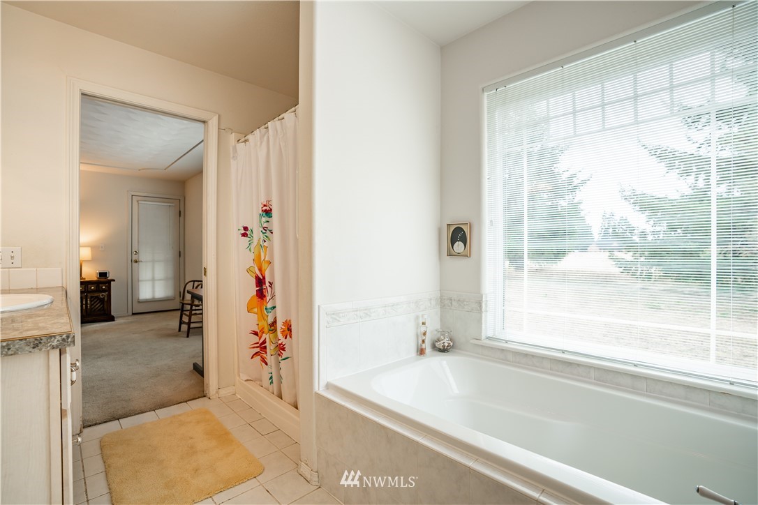 18806 Sams Place Southwest Rochester, WA 98579 - Photo 31 of 40 a bathroom with a bathtub and a shower