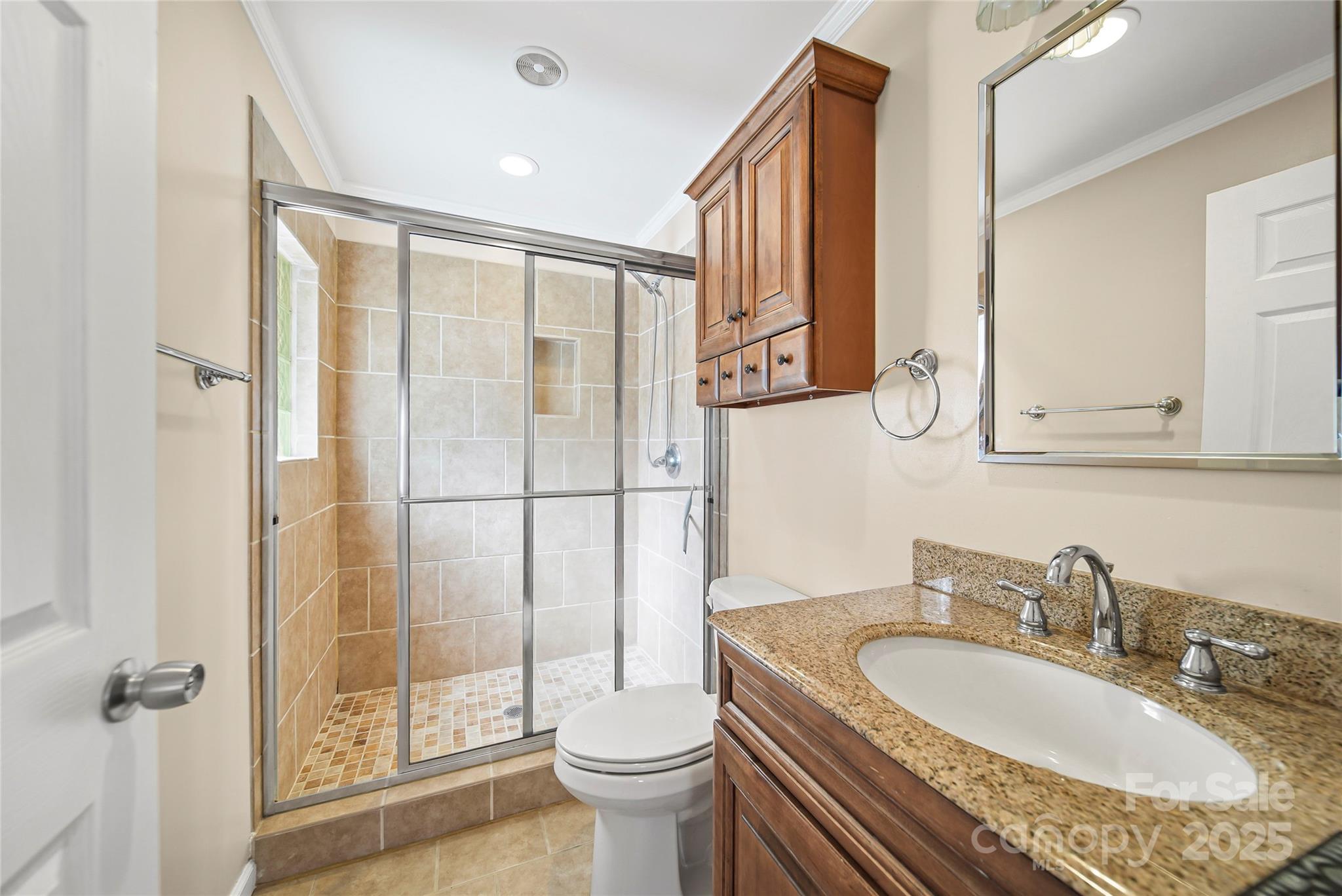 125 Lowder Road Albemarle, NC 28001 - Photo 22 of 37 a bathroom with a granite countertop sink a toilet a mirror and shower