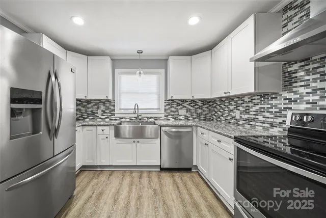 a kitchen with a sink stove and refrigerator