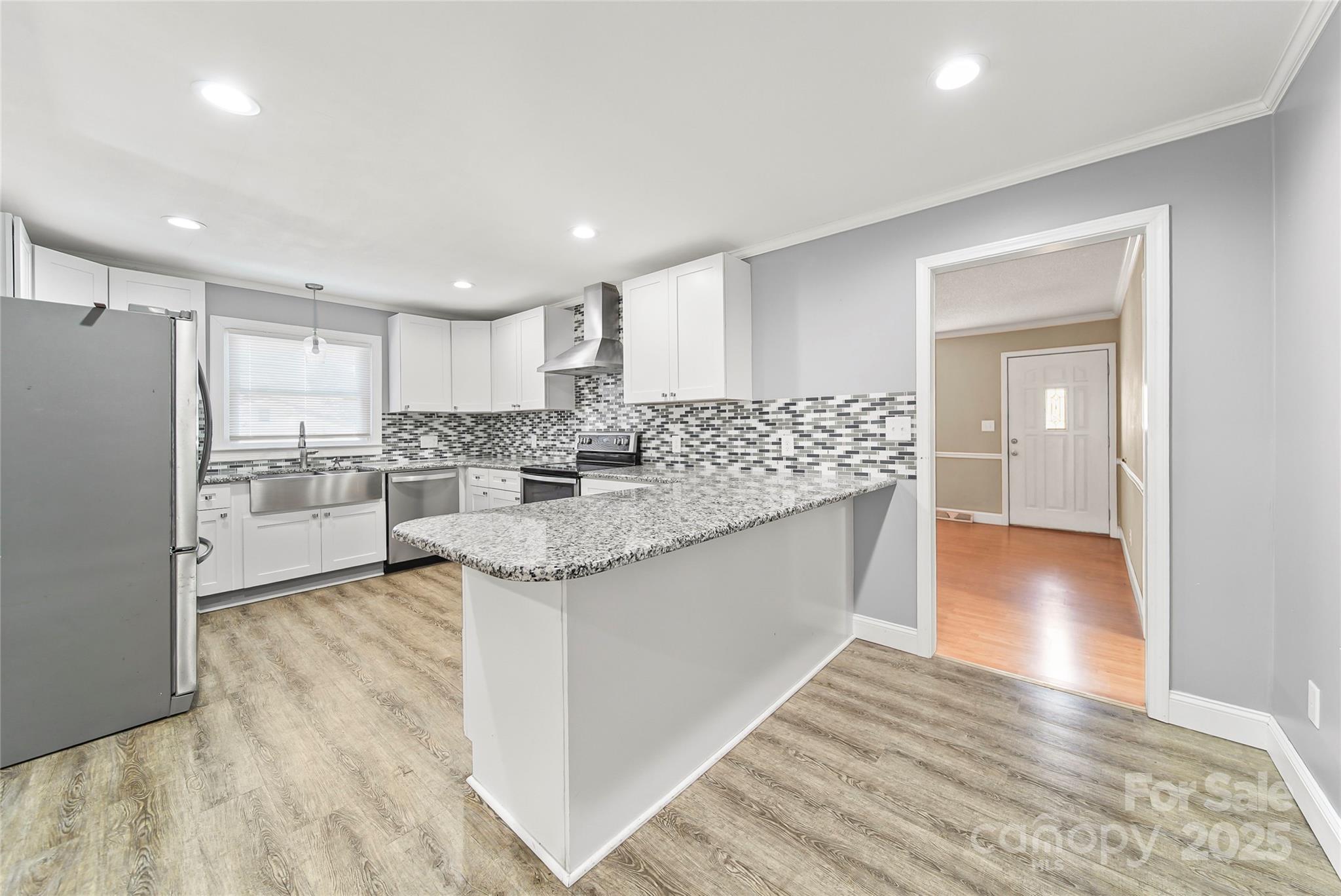 125 Lowder Road Albemarle, NC 28001 - Photo 9 of 37 a kitchen with stainless steel appliances granite countertop a sink and a refrigerator