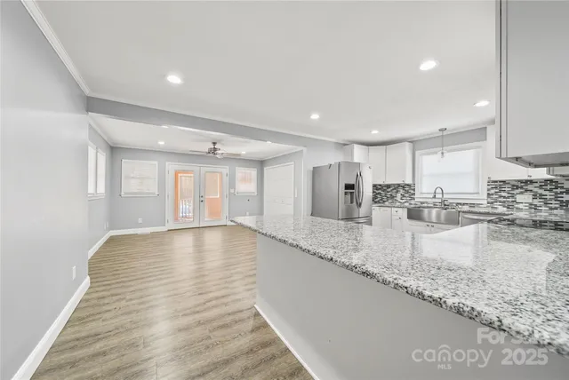 a view of a kitchen with a sink and cabinets