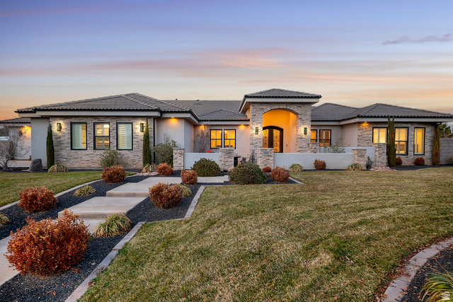 2407 East 4040th Street South St. George, UT 84790 - Photo 1 of 1 View of front of property featuring a yard, stucco siding, and stone siding