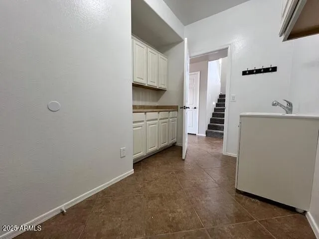a kitchen with a refrigerator and a stove top oven