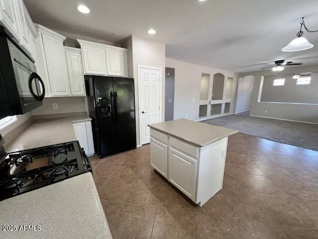 a kitchen with a stove a refrigerator and a sink