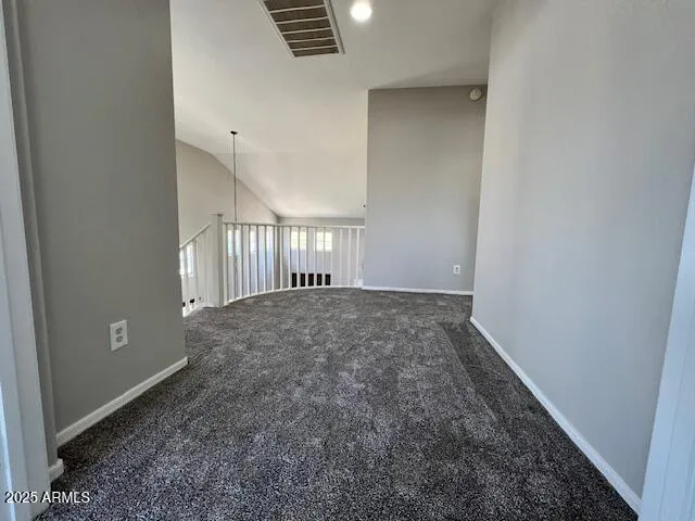 a view of room with chandelier fan and windows
