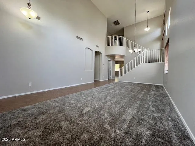 an empty room with staircase and white walls
