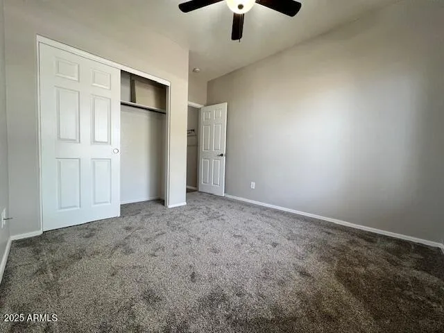 a view of an empty room with a ceiling fan