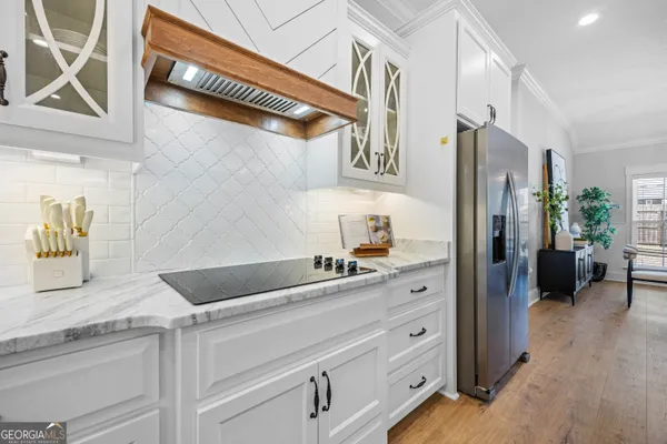 a view of a kitchen center island cabinets and stainless steel appliances