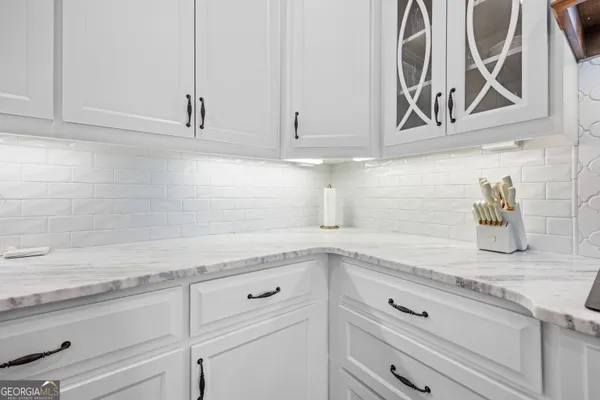 a kitchen with stainless steel appliances granite countertop a refrigerator a stove a sink dishwasher and a dining table with wooden floor