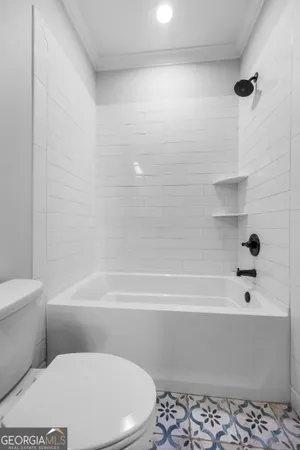 a white toilet sitting next to a white sink