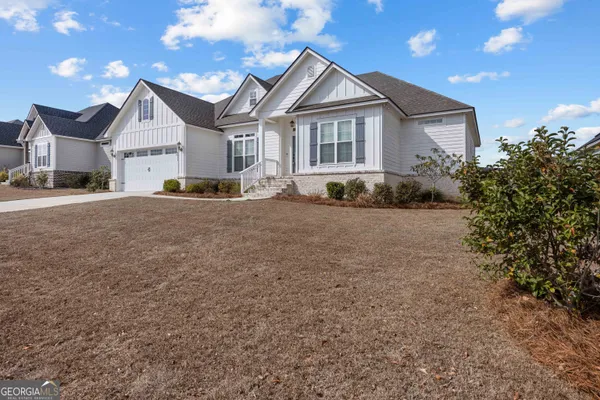 a view of a house with a yard and garage