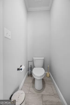 an empty room with chandelier fan and windows