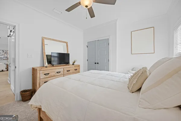 a view of a house with a yard and large tree