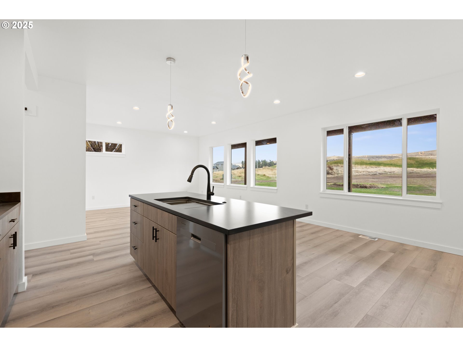 240 Heritage Lane Union, OR 97883 - Photo 11 of 36 a kitchen with a sink a window and wooden floor