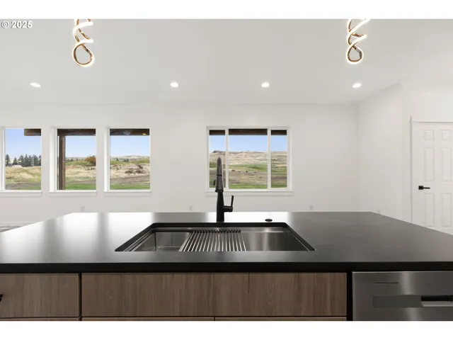 a kitchen with a sink a counter top space and a window