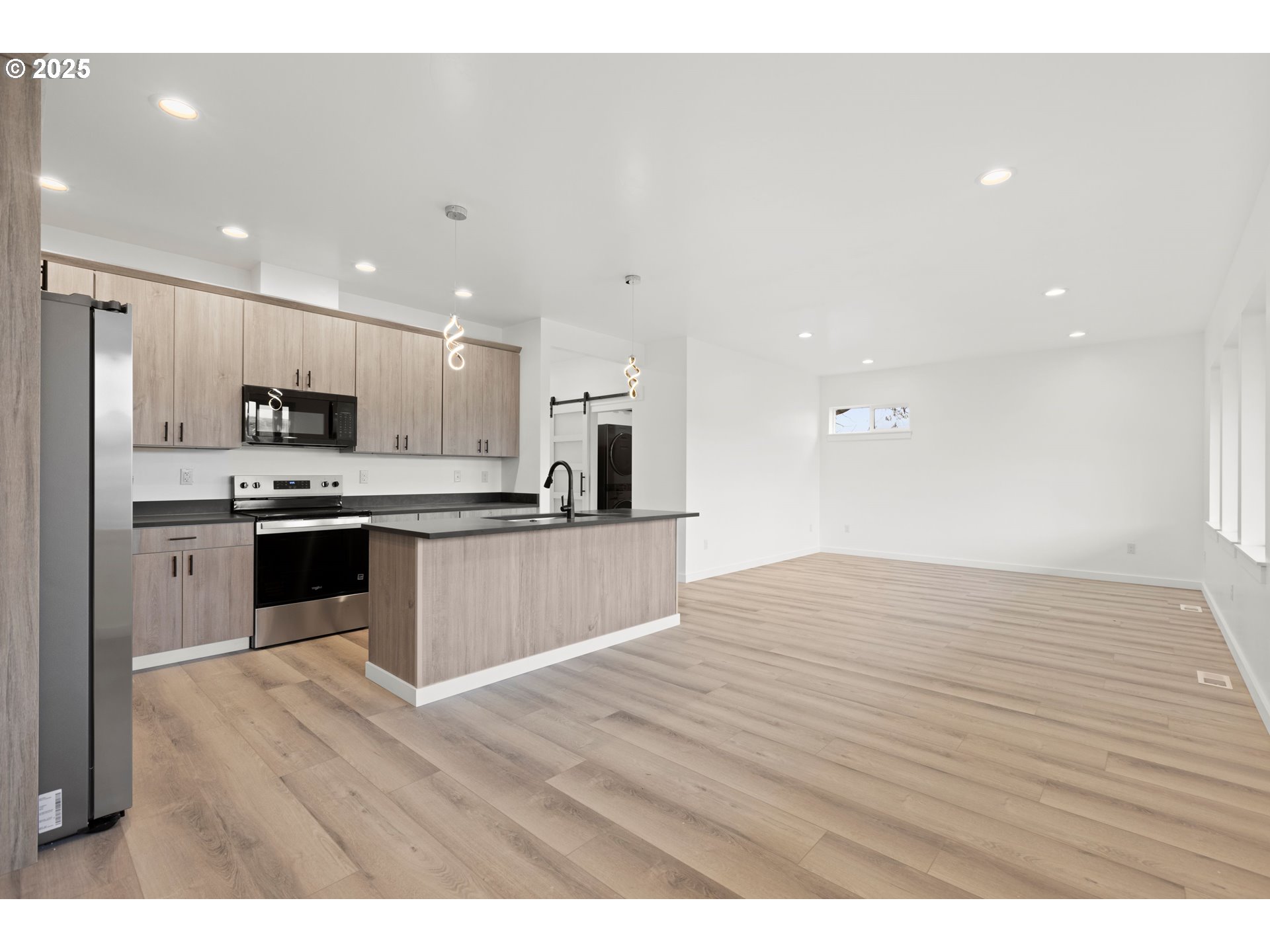 240 Heritage Lane Union, OR 97883 - Photo 18 of 36 a open kitchen with kitchen island a sink stainless steel appliances and white cabinets