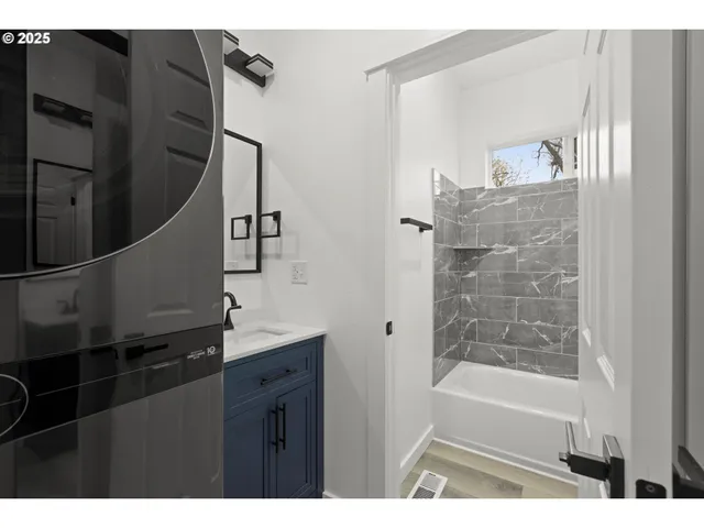 a bathroom with a bathtub sink and mirror