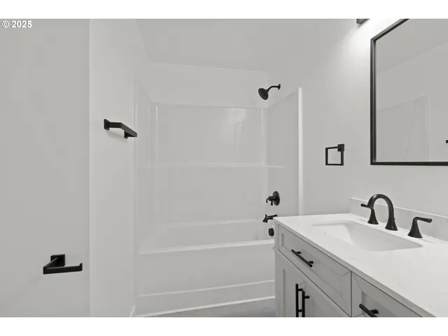 a bathroom with a sink a mirror and a bathtub