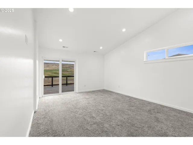 a spacious bathroom with a double vanity sink a mirror and a bathtub