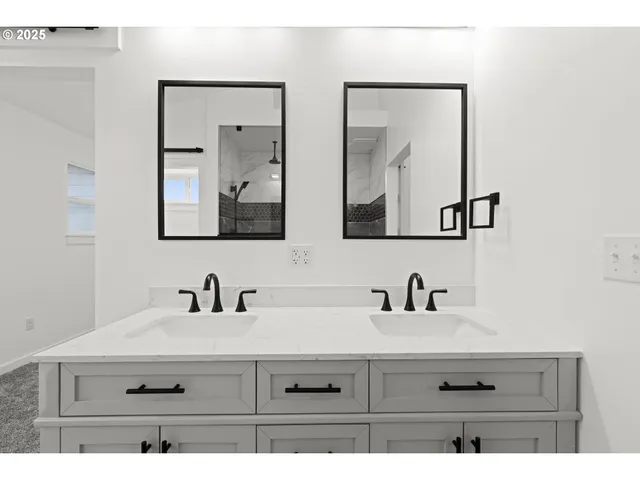 a bathroom with a sink mirror and a shower