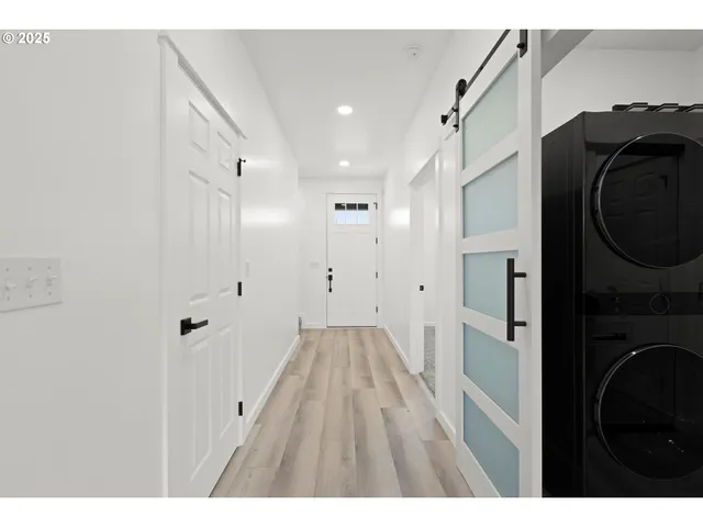 a view of a hallway with washer and dryer