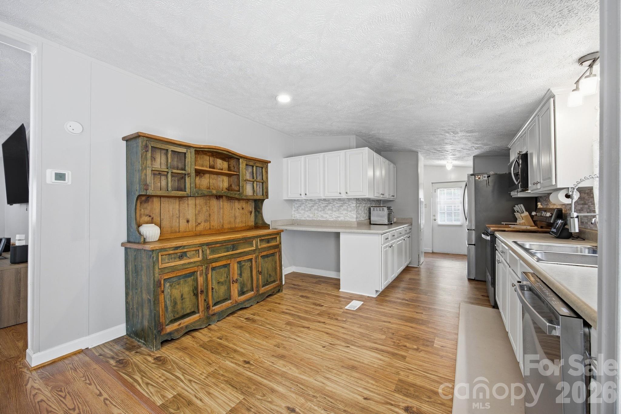 675 Overcash Road Salisbury, NC 28147 - Photo 19 of 48 a kitchen with stainless steel appliances granite countertop a stove a sink and a refrigerator