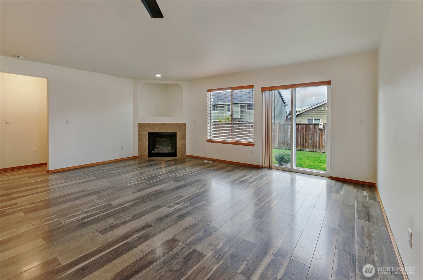 9114 Canal Road Southeast Yelm, WA 98597 - Photo 12 of 40 a view of an empty room with wooden floor and a window