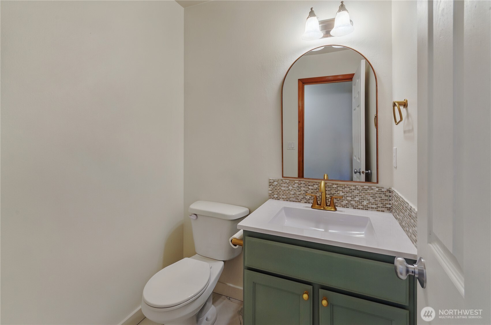 9114 Canal Road Southeast Yelm, WA 98597 - Photo 17 of 40 a bathroom with a toilet sink vanity and mirror