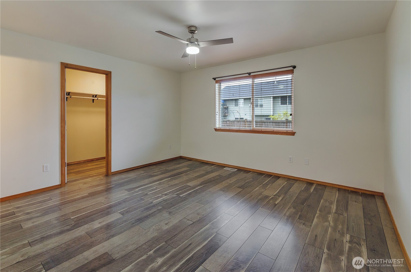 9114 Canal Road Southeast Yelm, WA 98597 - Photo 18 of 40 a view of an empty room with wooden floor and a window