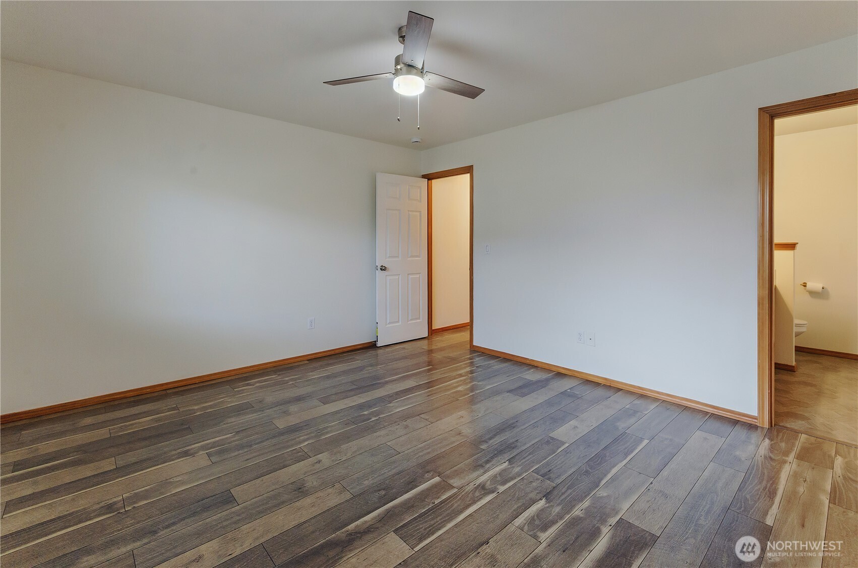 9114 Canal Road Southeast Yelm, WA 98597 - Photo 19 of 40 a view of an empty room with wooden floor and a window