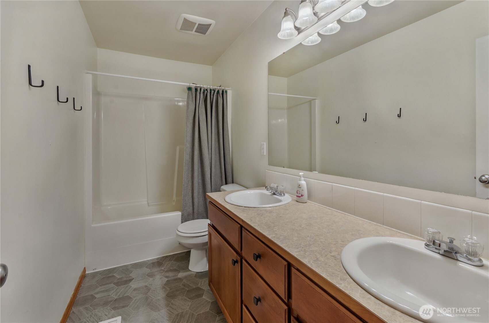 9114 Canal Road Southeast Yelm, WA 98597 - Photo 24 of 40 a bathroom with a granite countertop sink a toilet a mirror and shower