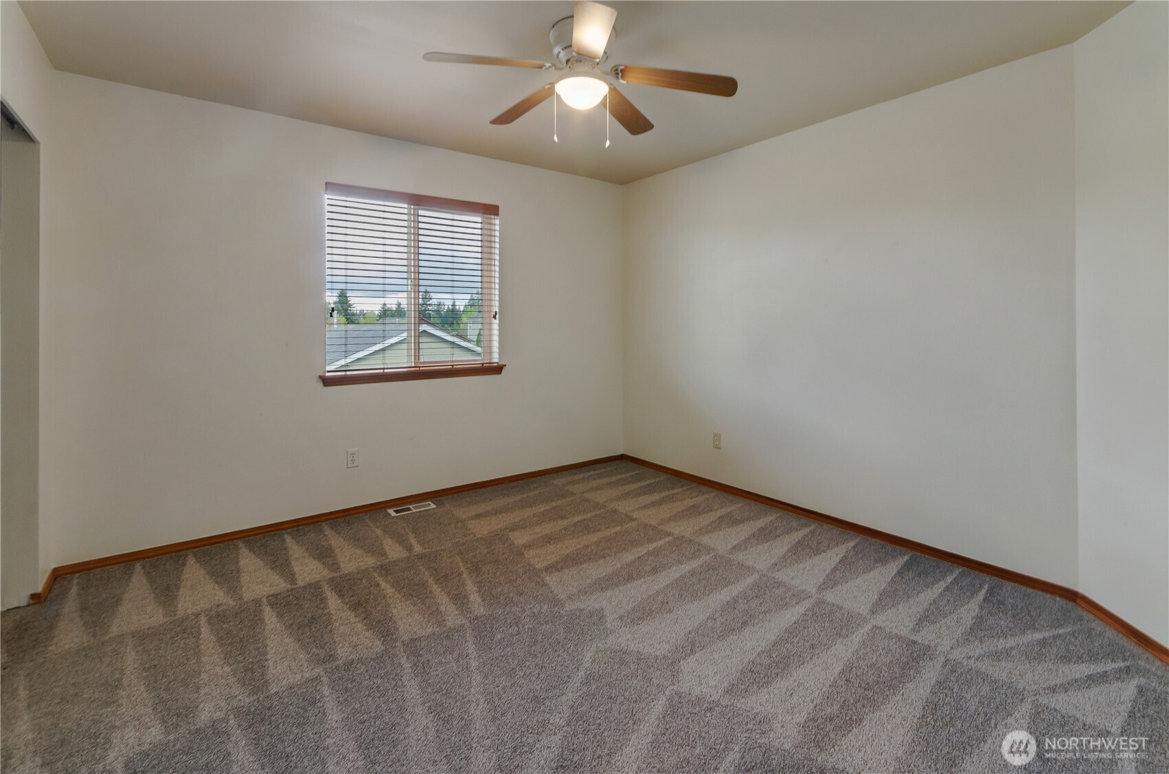 9114 Canal Road Southeast Yelm, WA 98597 - Photo 27 of 40 a view of an empty room with window and chandelier fan
