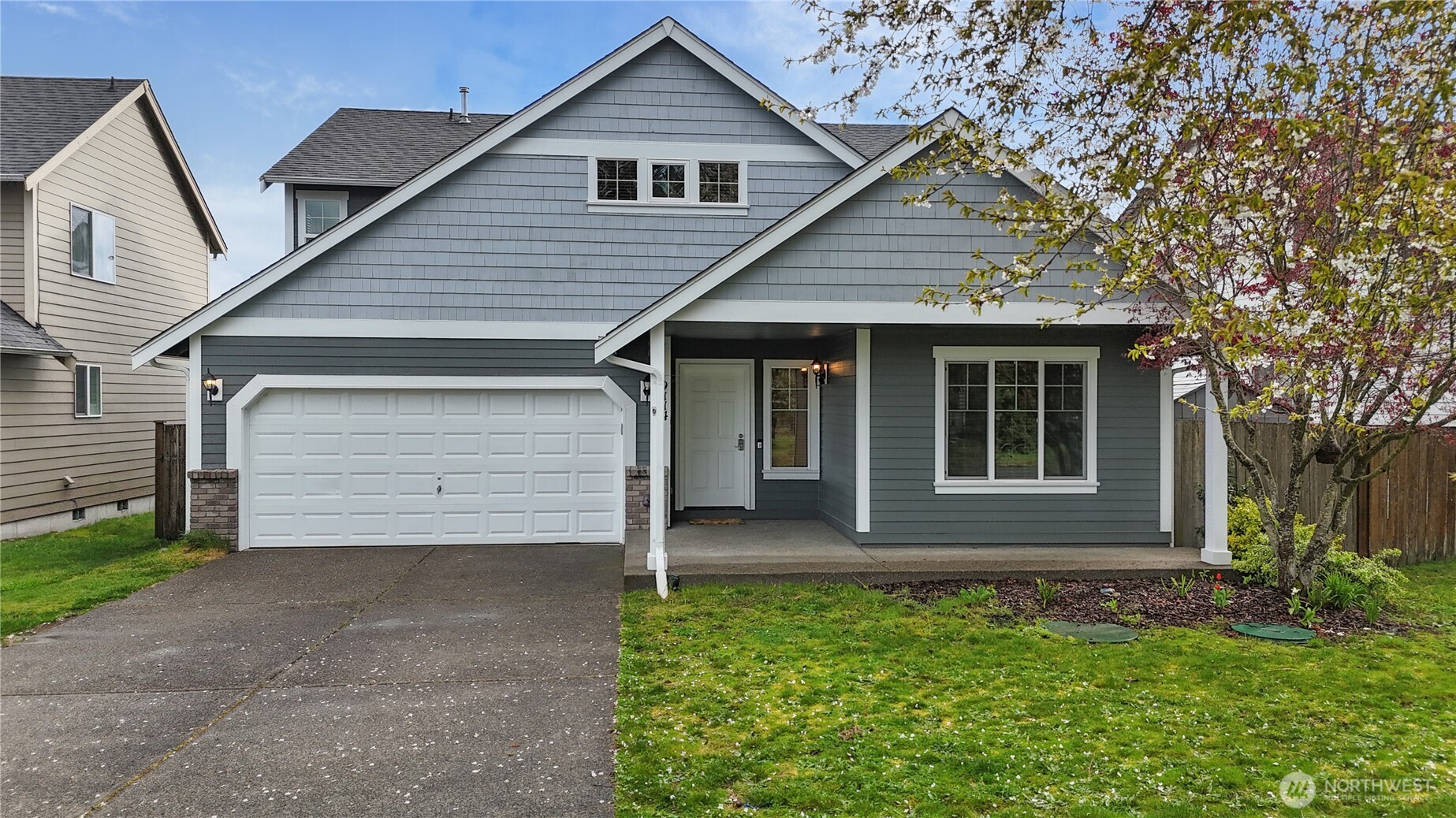 9114 Canal Road Southeast Yelm, WA 98597 - Photo 3 of 40 a front view of a house with a garden