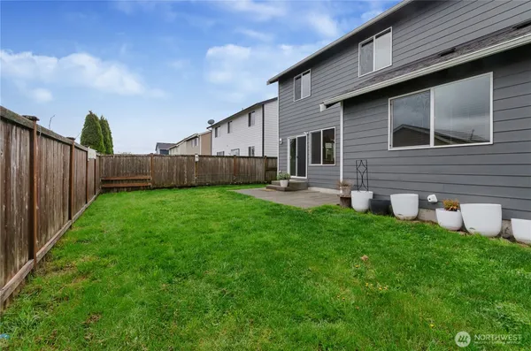 a backyard of a house with table and chairs