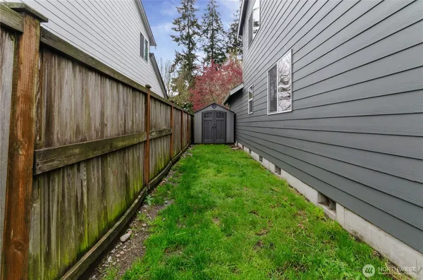 a view of a house with backyard and a chair