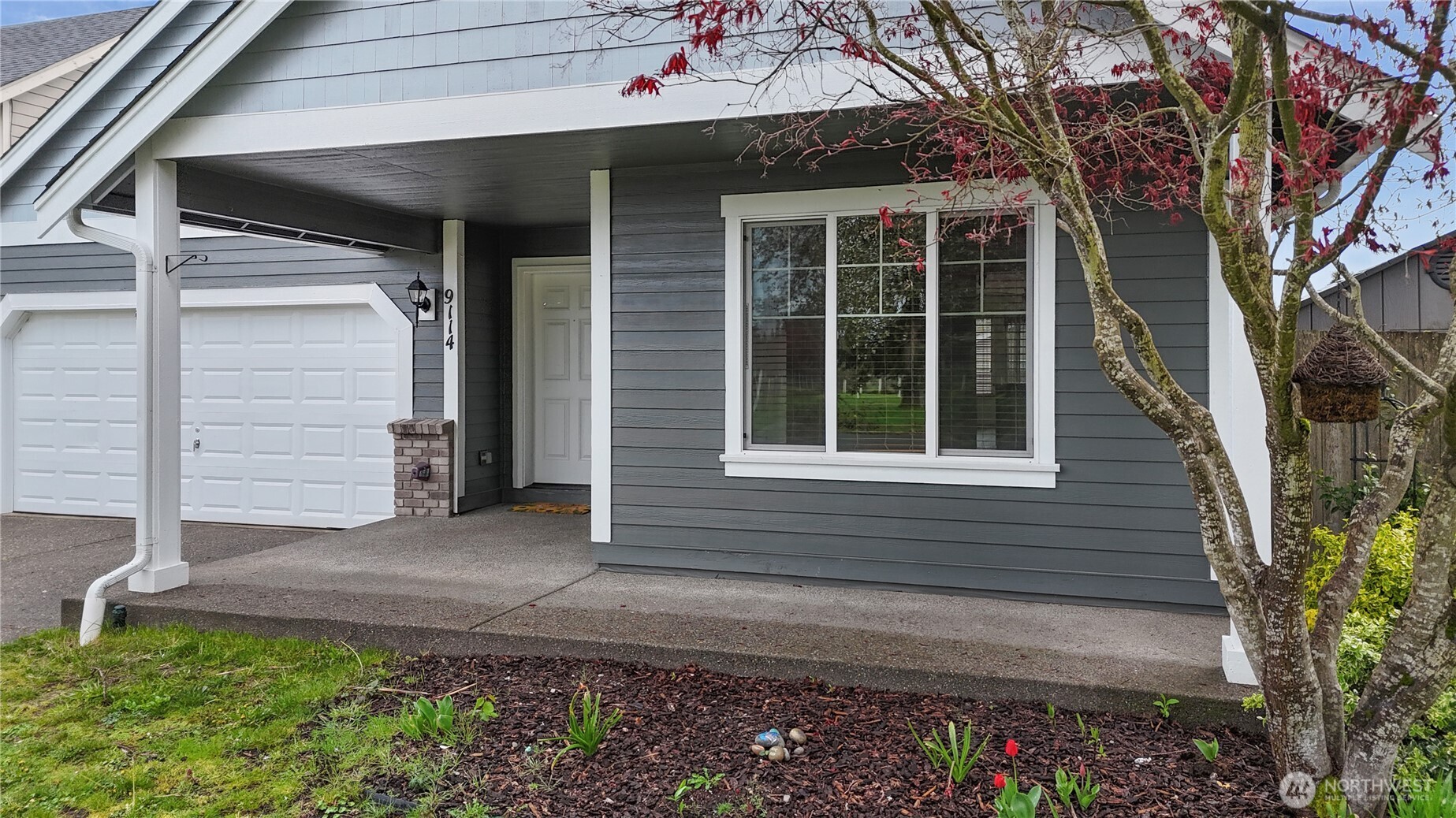 9114 Canal Road Southeast Yelm, WA 98597 - Photo 4 of 40 a front view of a house with a yard