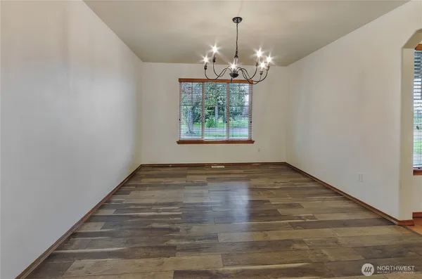 a view of a room with window wooden floor and chandelier