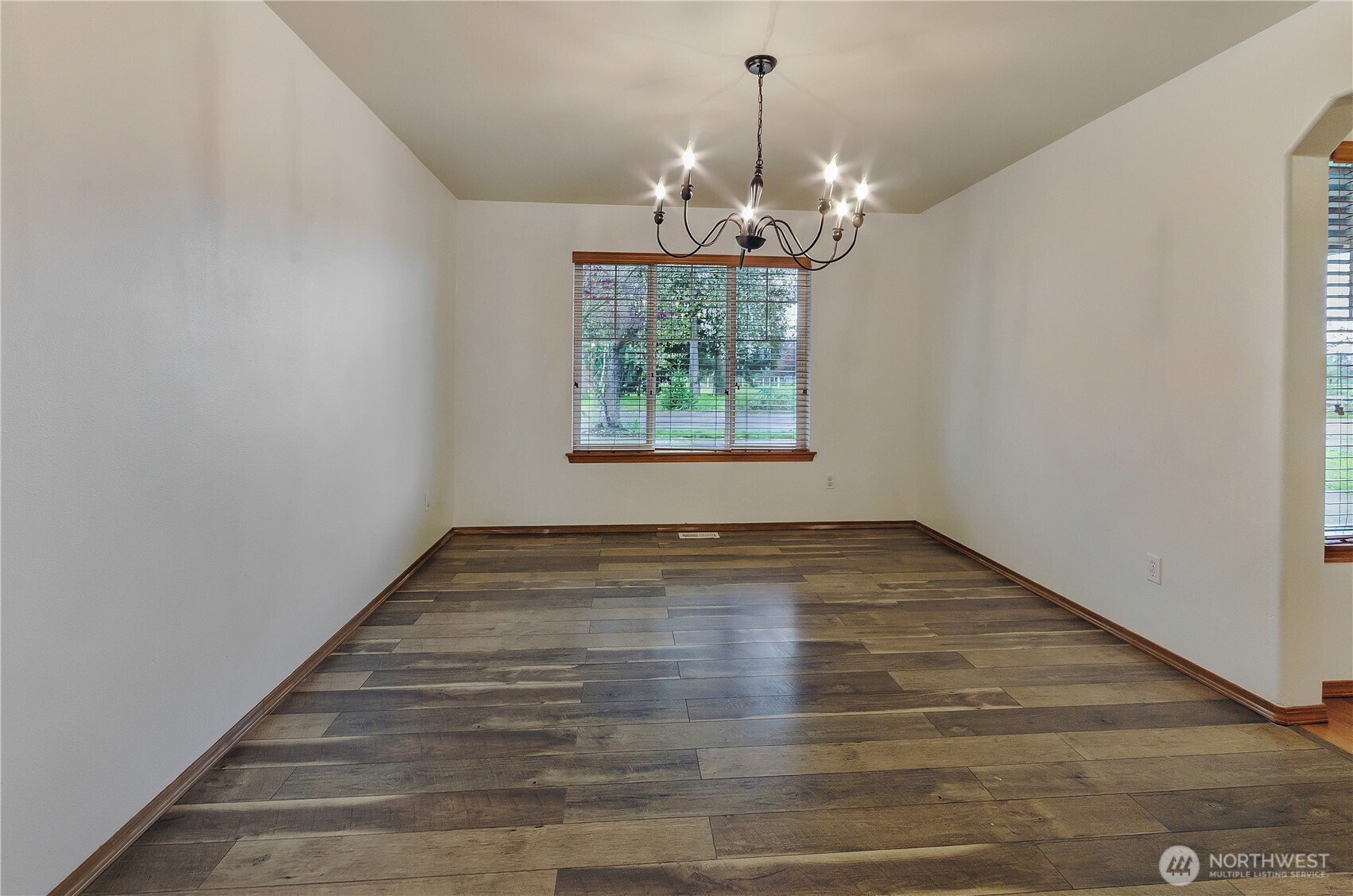 9114 Canal Road Southeast Yelm, WA 98597 - Photo 6 of 40 a view of a room with window wooden floor and chandelier