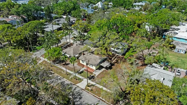 an aerial view of residential house with parking and yard
