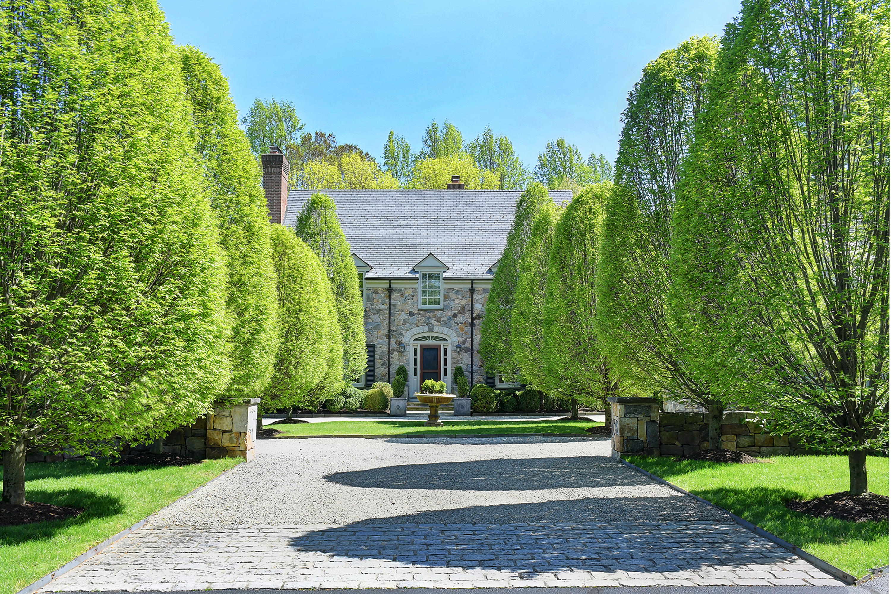 507 Silvermine Road New Canaan, CT 06840 - Photo 8 of 40 a front view of a house with a yard and trees