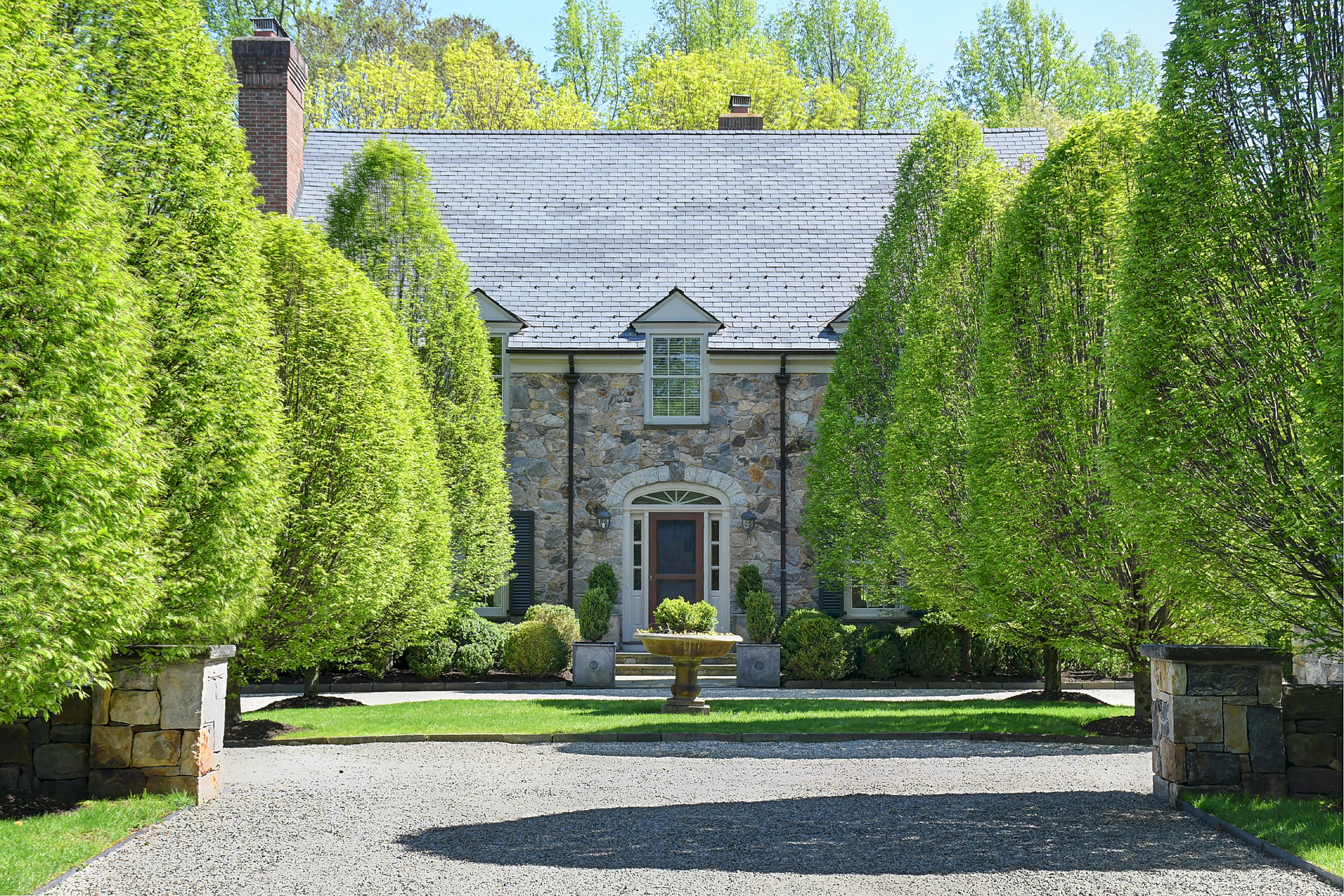 507 Silvermine Road New Canaan, CT 06840 - Photo 9 of 40 a front view of a house with a garden