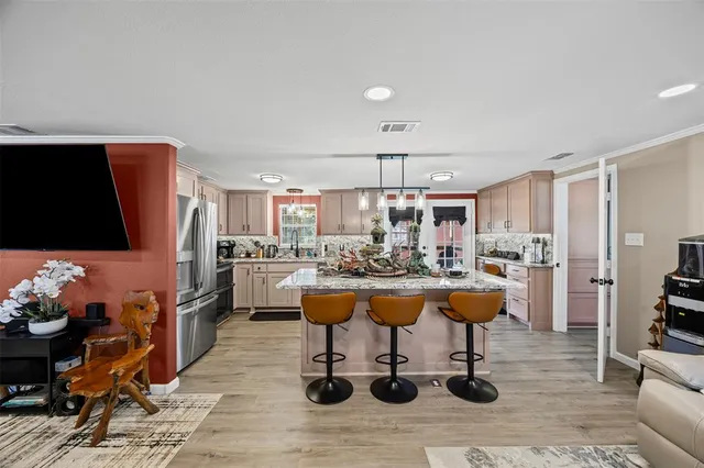 a living room with lots of furniture and kitchen view