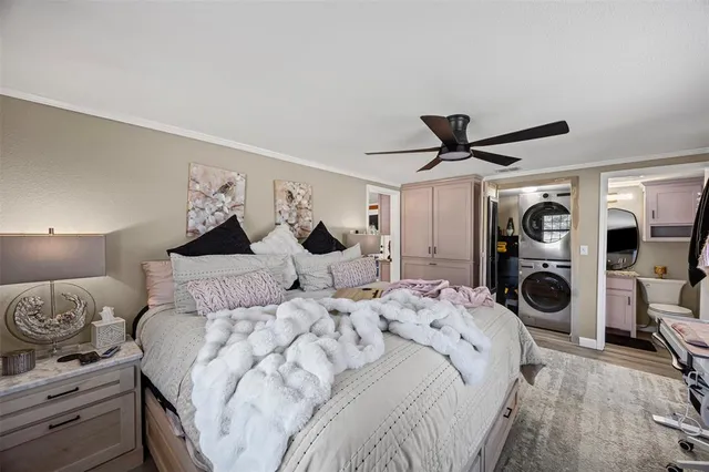 a bedroom with a bed and a view of kitchen