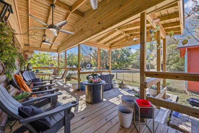 a view of a patio with chairs and potted plants